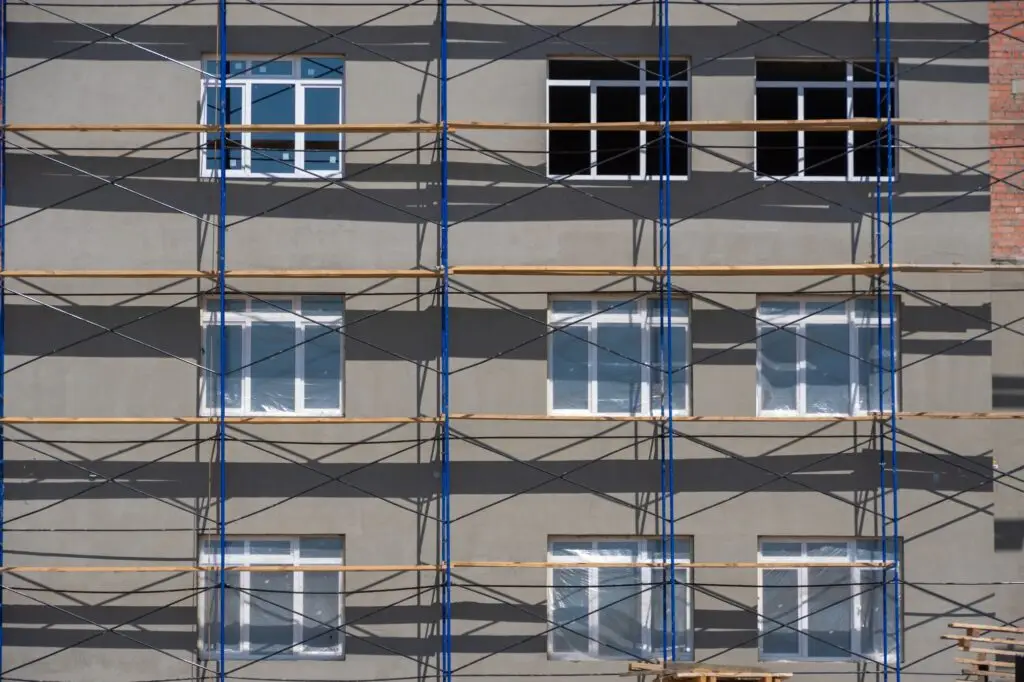 Facade restoration work. Scaffolding in front of facade. Building under construction with scaffolds